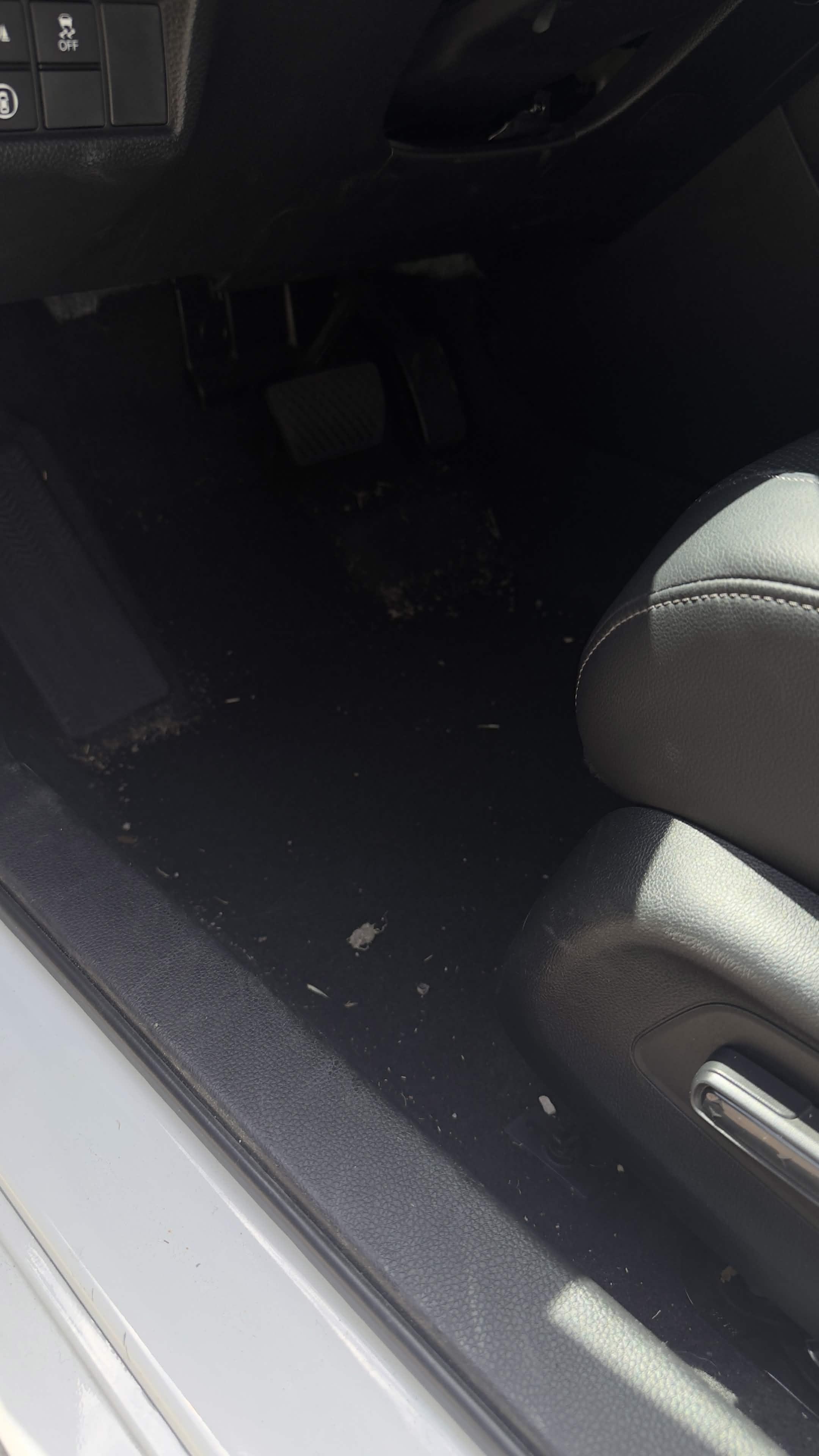Sedan floor before interior detail — dusty carpet with debris