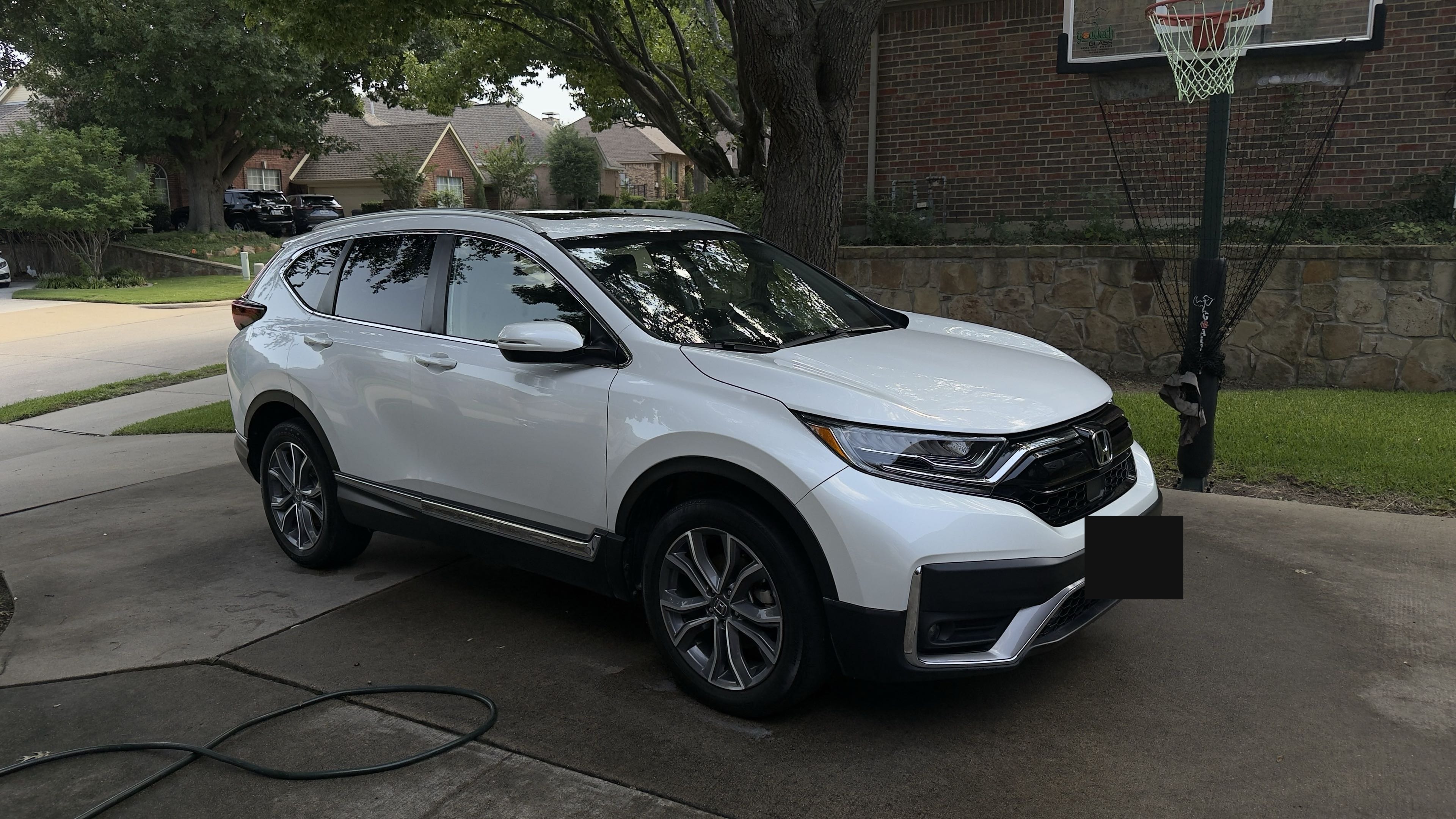 Freshly detailed white Honda CR-V with a glossy hand-washed finish